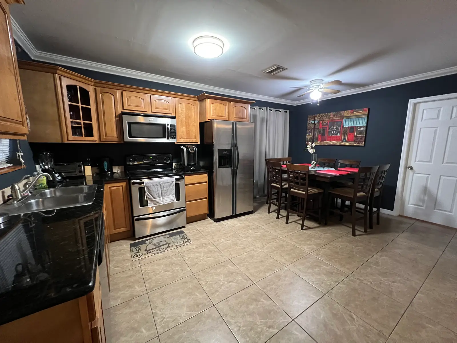 Bliss 7 kitchen and dining room with stainless appliances and a table for six