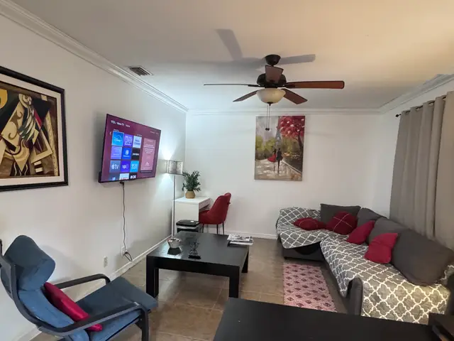 Bliss 7 living room with sectional sofa, smart TV and work desk