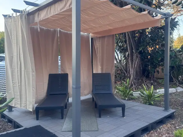 Shared pergola with lounge chairs